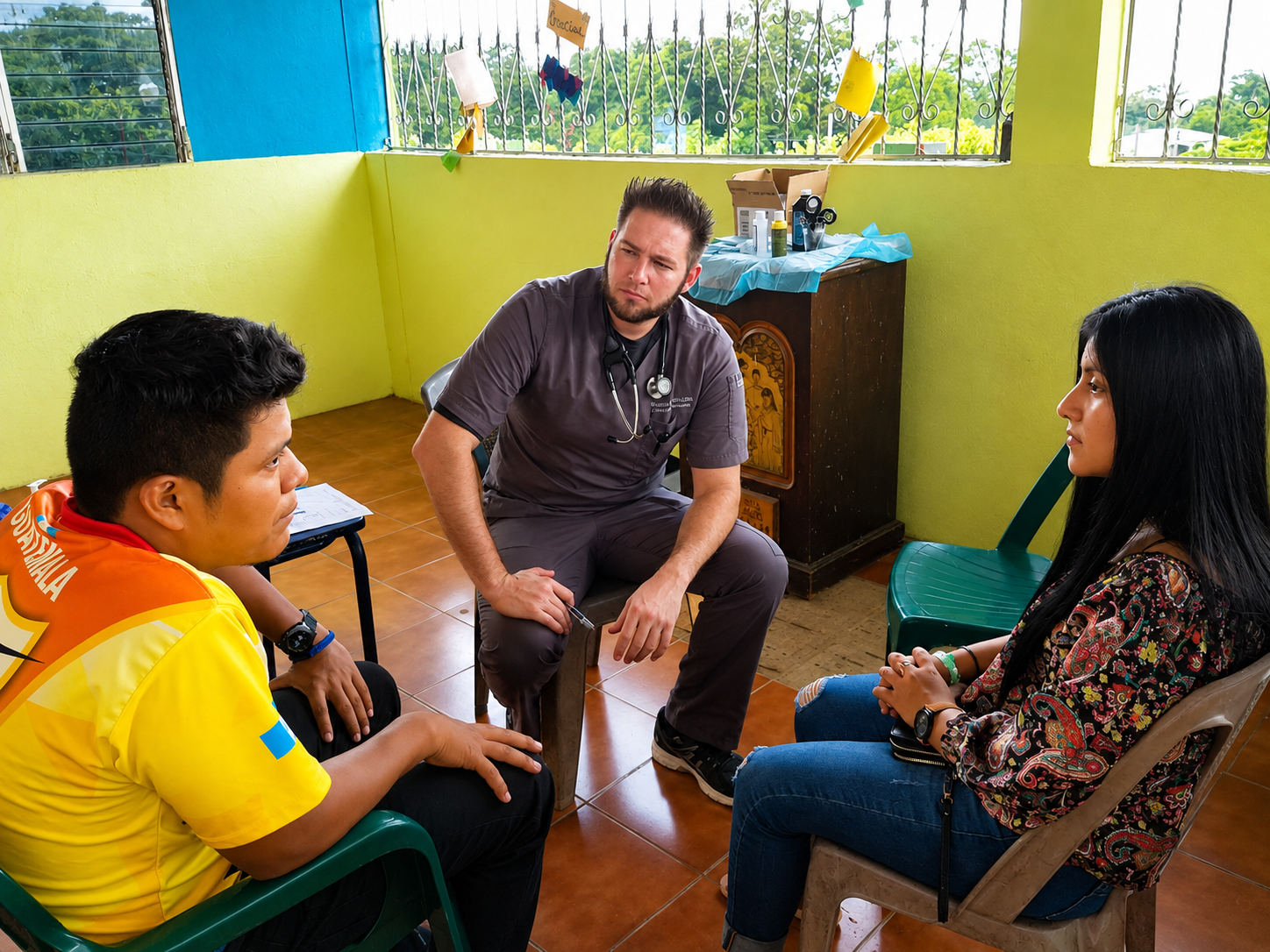 Hope for Humanity doctor consulting with patients in a bright yellow-walled room in Guatemala