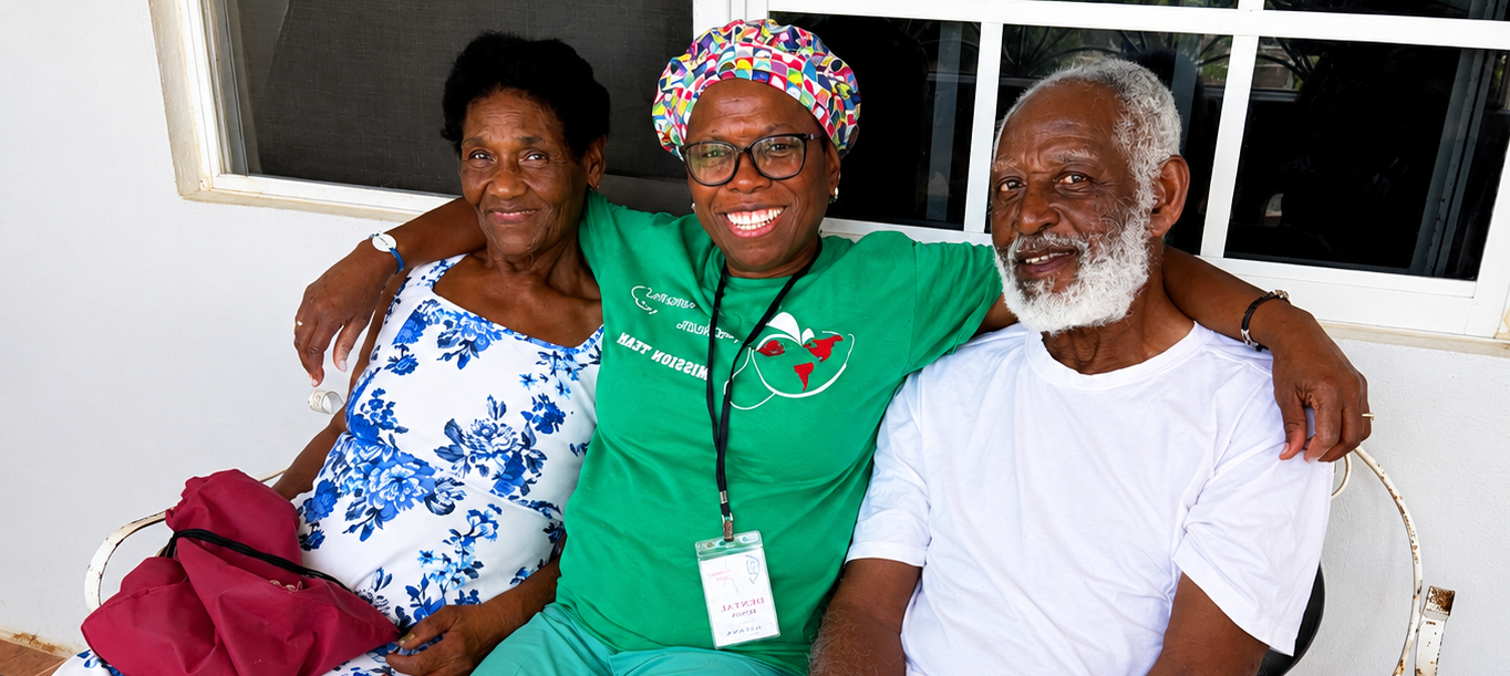 Hope for Humanity volunteer in yellow shirt smiling with elderly couple on porch
