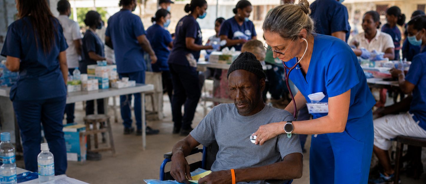 Hope for Humanity nurse examining wheelchair patient at community clinic