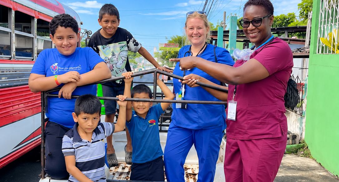 Hope for Humanity nurses with children at community outreach by bus