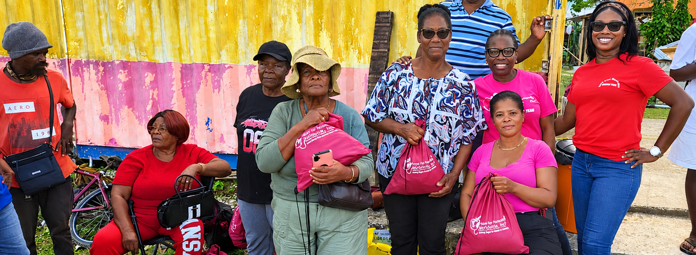 Hope for Humanity volunteers and community members gathered together at outdoor outreach event with pink donation bags