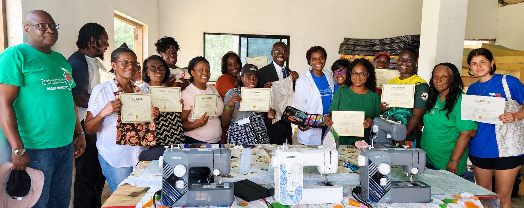 Hope for Humanity sewing workshop graduation celebration with community members holding certificates and sewing machines